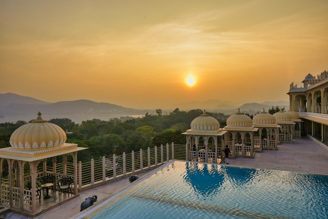 Luxury palace resort and infinity pool at sunset in India